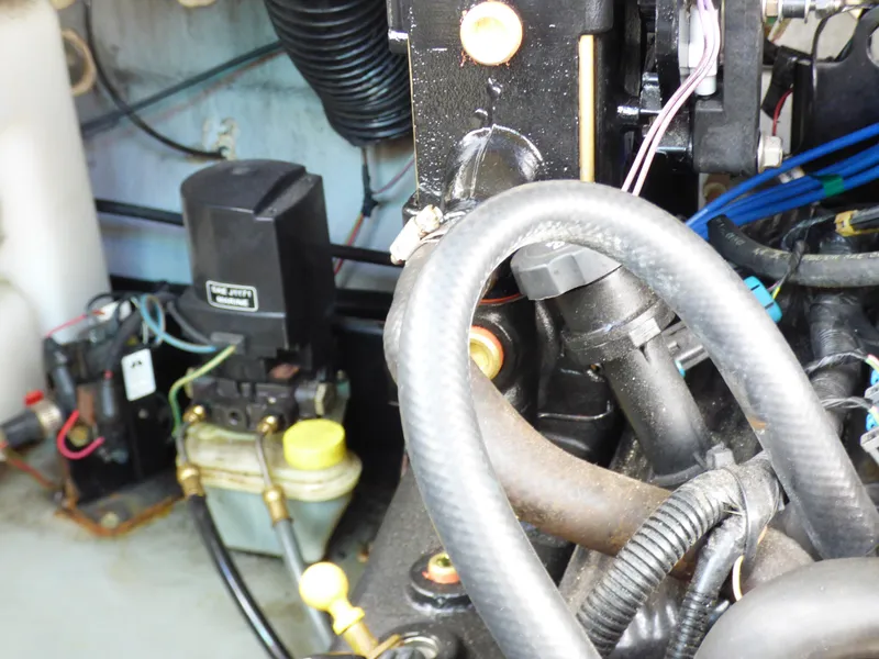 Engine compartment of a 2003 Sea Ray 260 Sundancer boat, showing mechanical components and wiring.