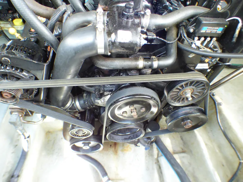 Engine of 2003 Sea Ray 260 Sundancer boat, showing belts and pulleys.