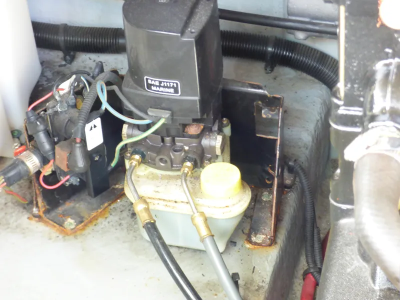 Engine compartment of 2003 Sea Ray 260 Sundancer with hydraulic components and wiring.