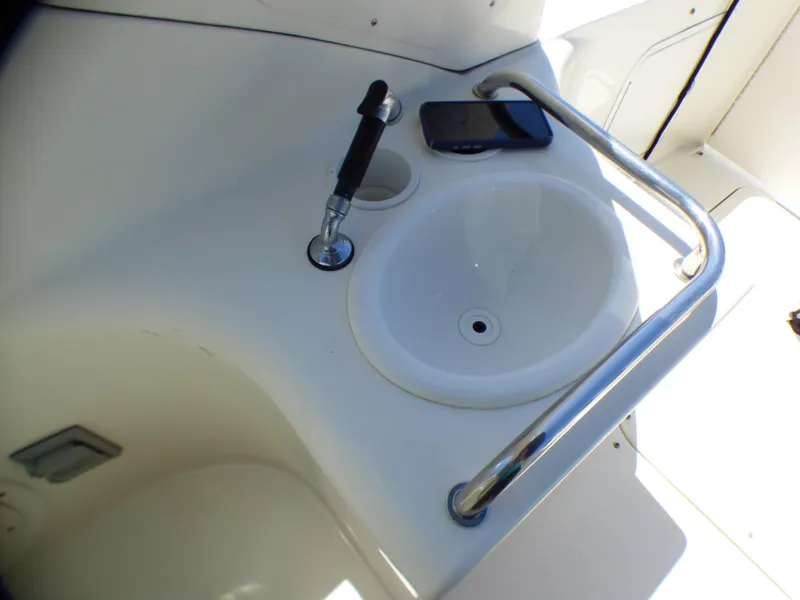2003 Sea Ray 260 Sundancer boat sink with faucet and railing.