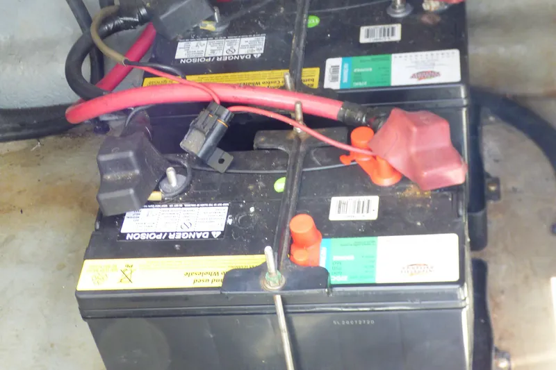 Batteries in a 2003 Sea Ray 260 Sundancer boat, showing wiring and connections.