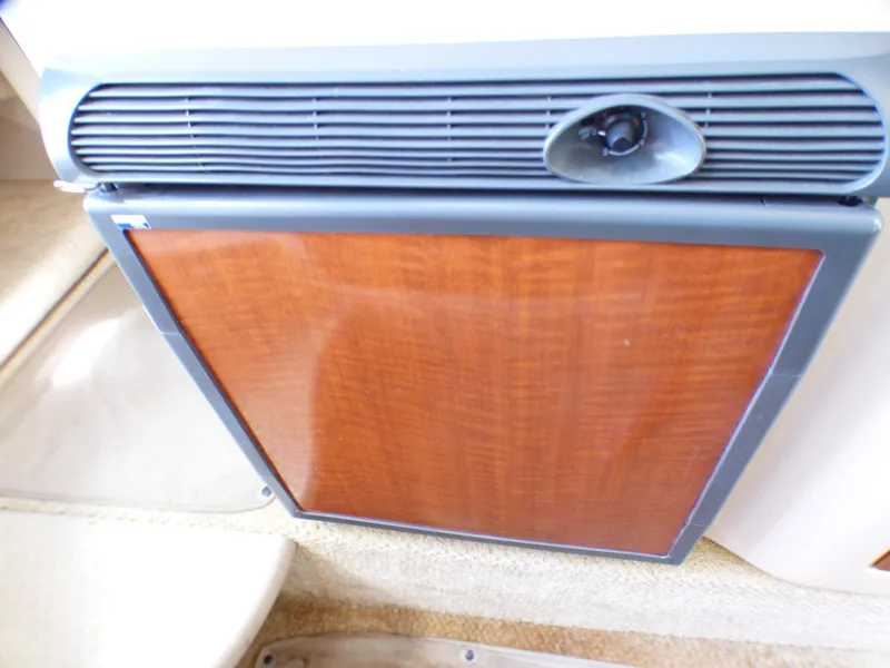 Wood-paneled refrigerator in 2003 Sea Ray 260 Sundancer boat interior.