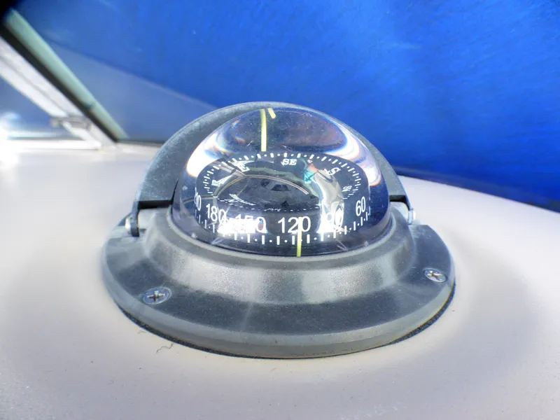 Compass on 2003 Sea Ray 260 Sundancer boat dashboard, under blue canopy.