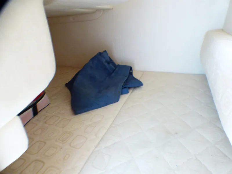 Interior cabin of 2003 Sea Ray 260 Sundancer with folded blue fabric.