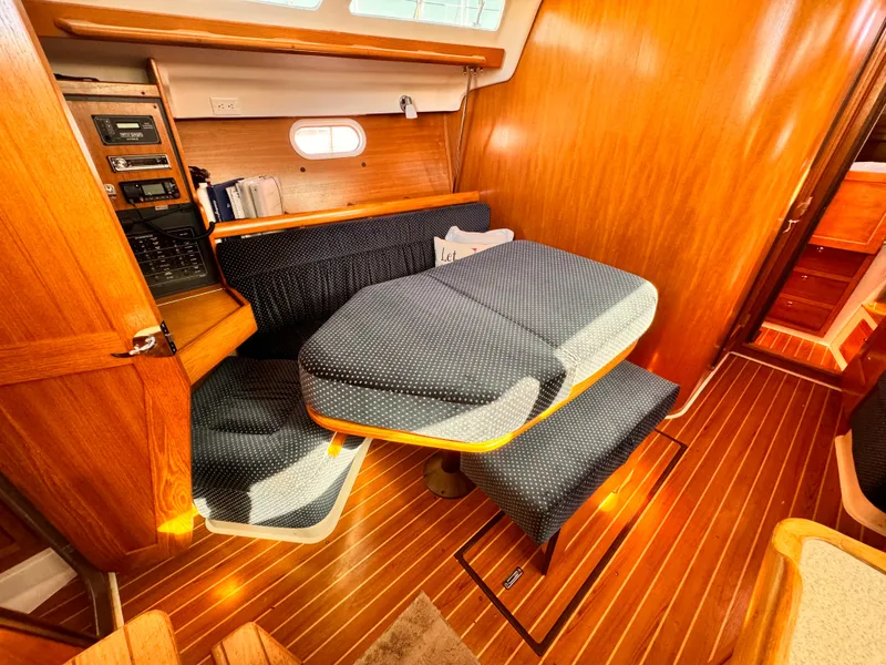 Interior of 2004 Catalina 350 sailboat with wooden finish and cushioned seating.