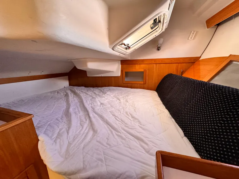 Cozy cabin interior of a 2004 Catalina 350 sailboat with a comfortable bed.