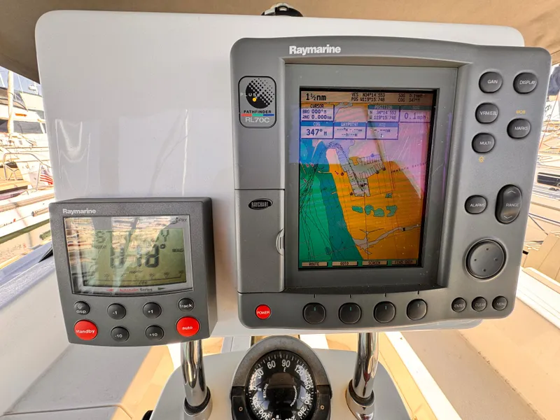 Navigation system on a 2004 Catalina 350 sailboat, featuring Raymarine displays and compass.
