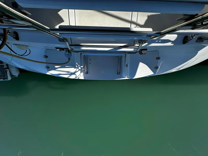 Stern view of a 2004 Catalina 350 sailboat above green water.