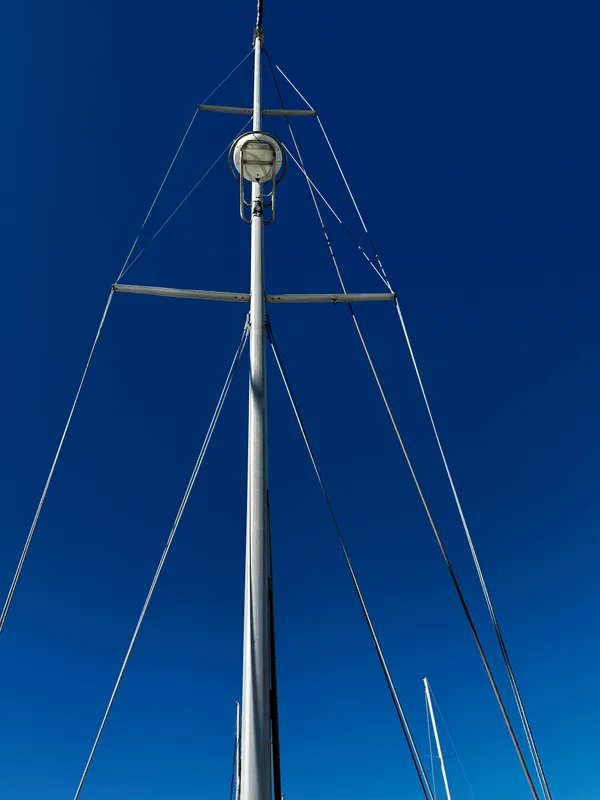 Mast of 2004 Catalina 350 sailboat against clear blue sky.