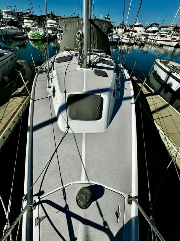 2004 Catalina 350 sailboat docked in a marina, surrounded by other boats.