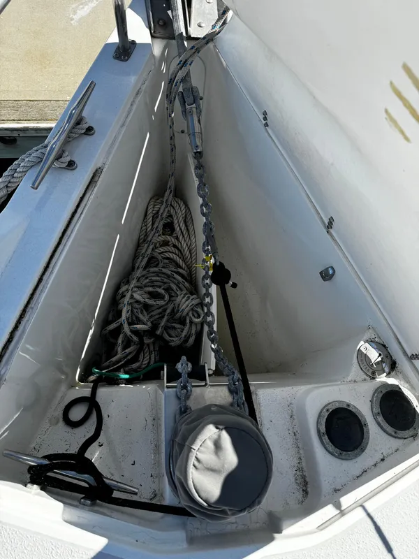 Anchor locker of a 2004 Catalina 350 sailboat with ropes and fittings.
