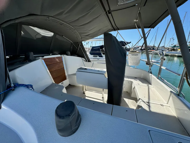 2004 Catalina 350 sailboat cockpit with canopy, docked at marina.
