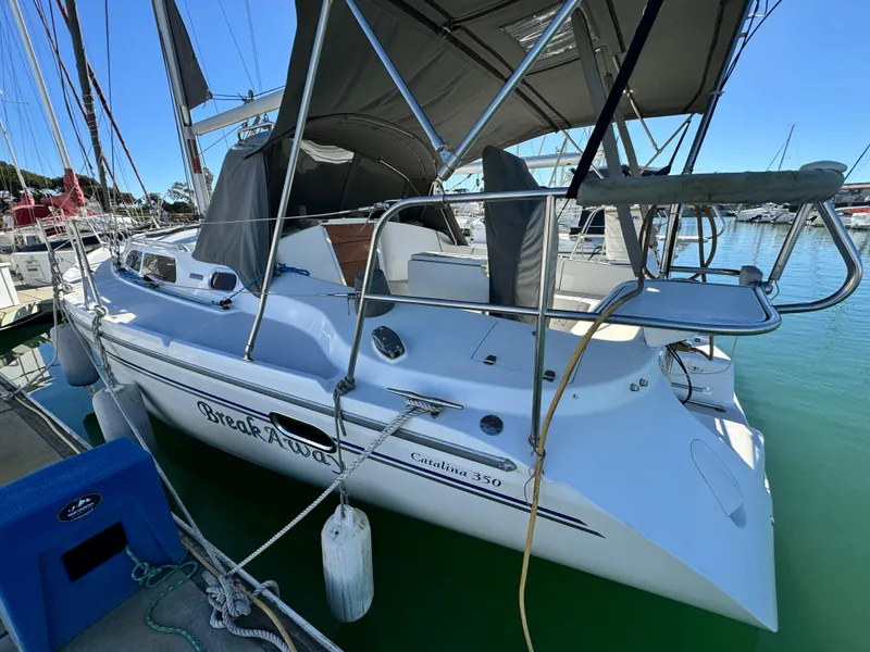 2004 Catalina 350 sailboat docked in marina, featuring sleek design and spacious deck.