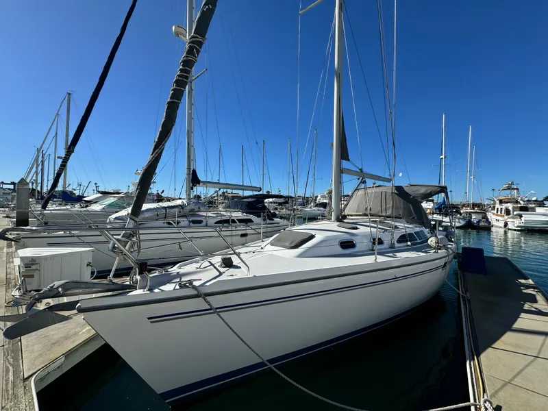 2004 Catalina 350 sailboat docked in a marina under clear blue skies.