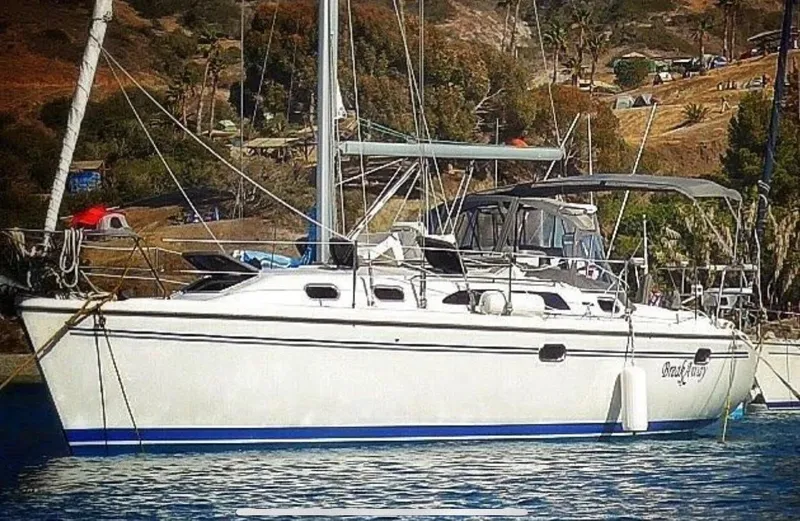 2004 Catalina 350 sailboat anchored in scenic coastal waters.