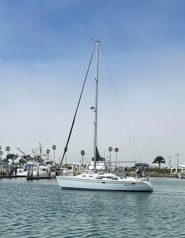 2004 Catalina 350 sailboat docked in a marina with clear skies.