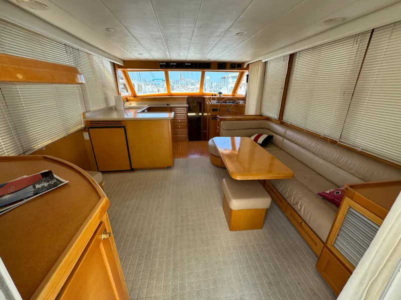 Interior of 1999 McKinna 47 Sedan yacht with spacious seating and wooden finishes.