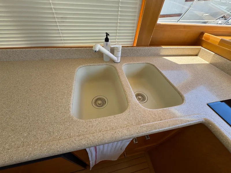 Dual sink countertop in 1999 McKinna 47 Sedan yacht kitchen.