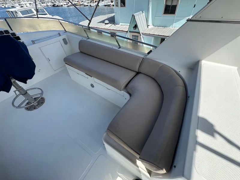 1999 McKinna 47 Sedan yacht interior with curved seating and marina view.