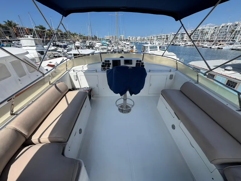 1999 McKinna 47 Sedan yacht interior with seating, docked in a marina.