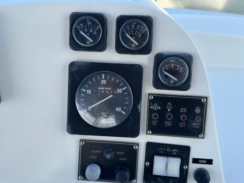 Instrument panel of a 1999 McKinna 47 Sedan boat with gauges and controls.