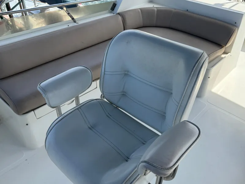 Captain's chair and seating area on 1999 McKinna 47 Sedan yacht.