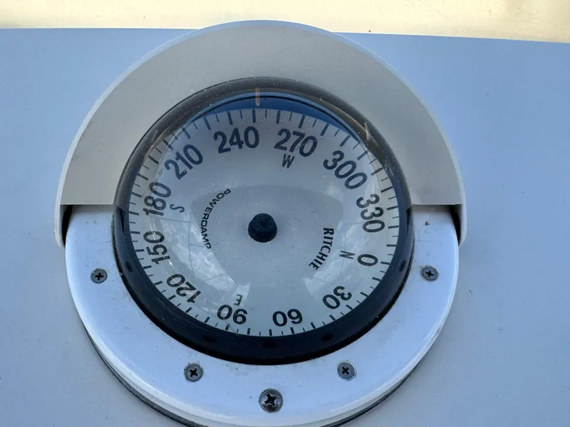 Compass on 1999 McKinna 47 Sedan boat, displaying directional degrees.