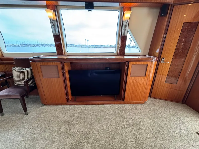 Luxurious interior of 2010 Norseman 80 yacht with wooden cabinetry and large windows.