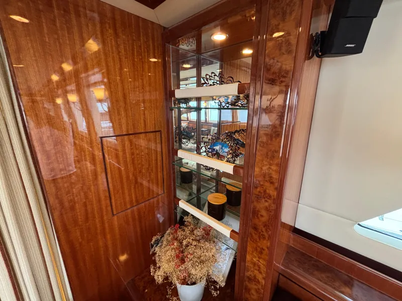 Luxurious Norseman 80 yacht interior with elegant wood paneling and decorative shelving, 2010 model.