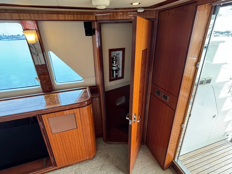 Luxurious interior of 2010 Norseman 80 yacht with wooden finishes and open door.