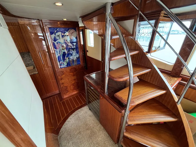 Luxurious wooden interior of 2010 Norseman 80 yacht with spiral staircase.