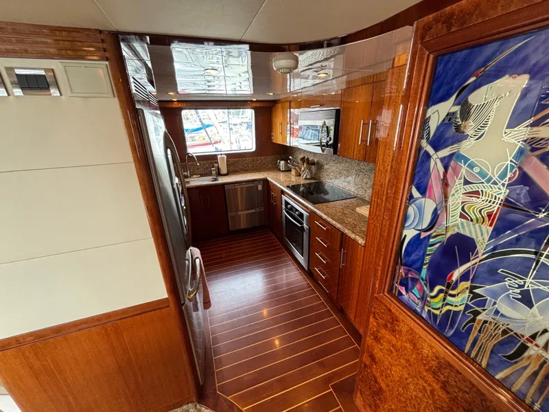 Luxurious 2010 Norseman 80 yacht kitchen with wood cabinetry and modern appliances.