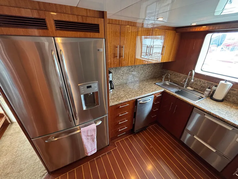 Luxurious yacht kitchen with stainless steel appliances, granite countertops, and wood cabinetry, Norseman 80, 2010.