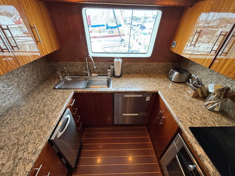 Luxurious yacht kitchen with granite countertops, stainless steel appliances, and wooden cabinetry. Norseman 80, 2010.