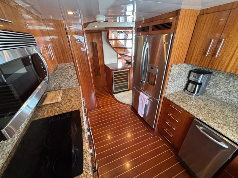 Luxurious kitchen interior of 2010 Norseman 80 yacht with modern appliances and wood finishes.