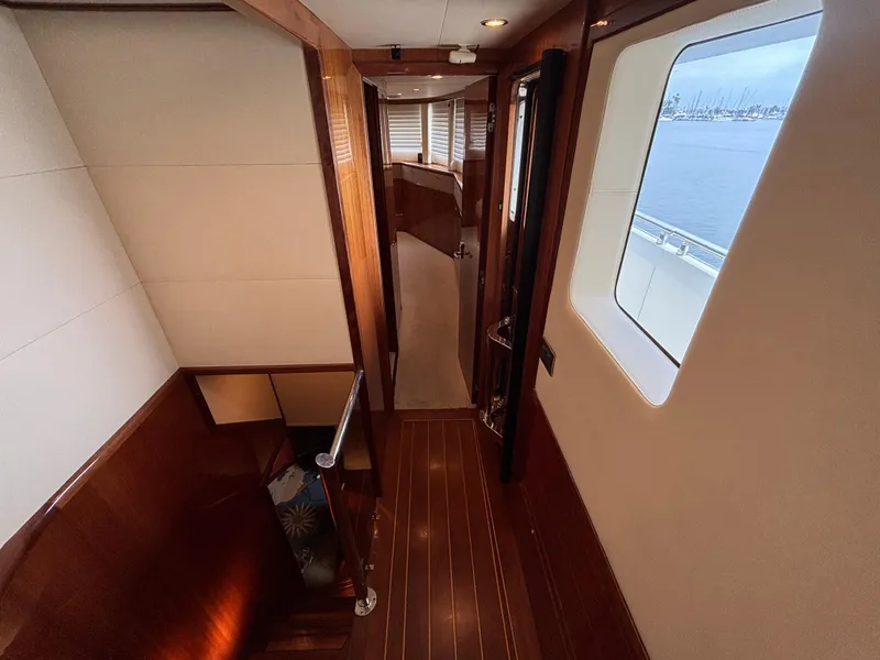 Luxurious interior of 2010 Norseman 80 yacht with wooden finishes and ocean view.