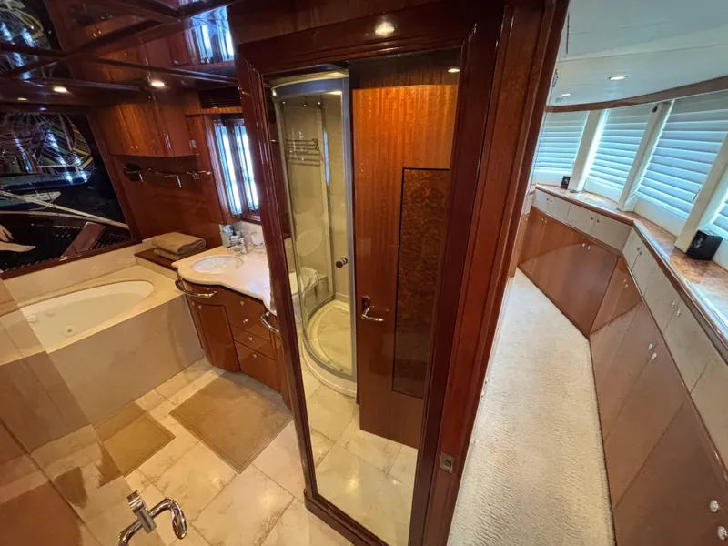 Luxurious bathroom interior on a 2010 Norseman 80 yacht, featuring wood finishes and modern amenities.