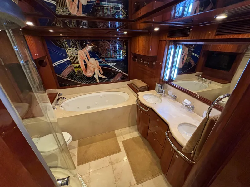 Luxurious yacht bathroom with jacuzzi, double sinks, and elegant wood finishes, Norseman 80, 2010.