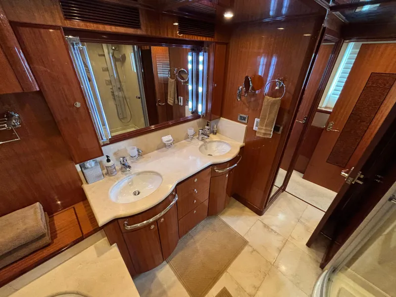 Luxurious bathroom in 2010 Norseman 80 yacht with dual sinks and elegant wood finish.