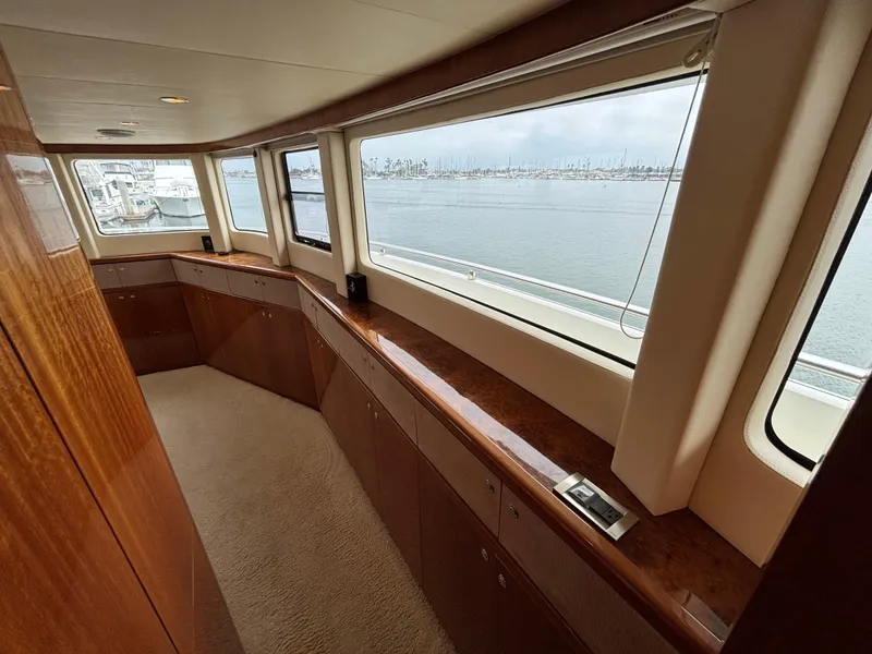Luxurious interior of 2010 Norseman 80 yacht with panoramic windows and wooden cabinetry.