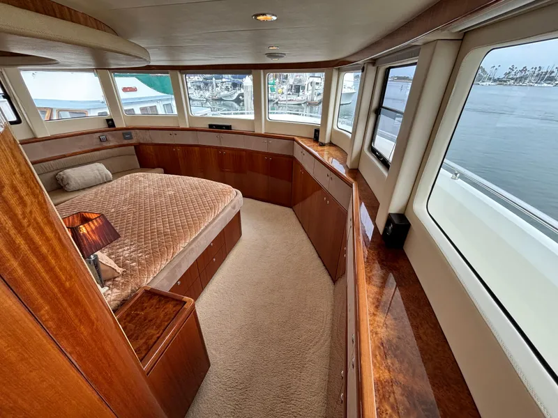 Luxurious Norseman 80 yacht bedroom with panoramic windows and elegant wood finishes, 2010 model.