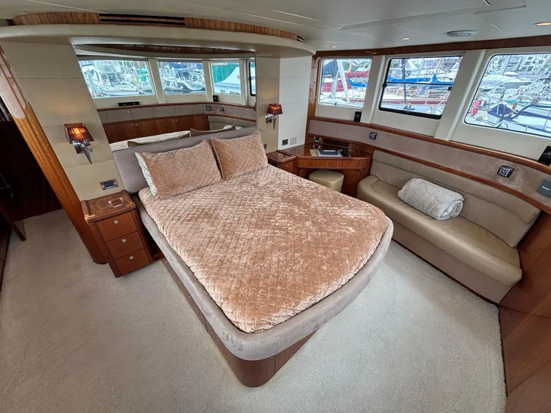 Luxurious Norseman 80 yacht bedroom interior with plush bedding and panoramic windows, 2010 model.