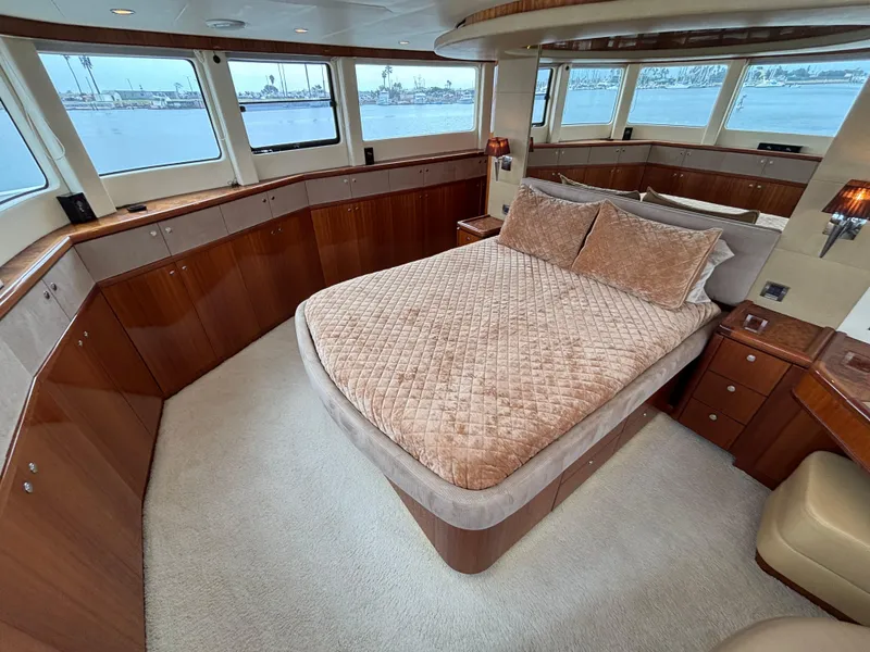 Luxurious Norseman 80 yacht bedroom with panoramic windows and elegant wood finishes, 2010 model.