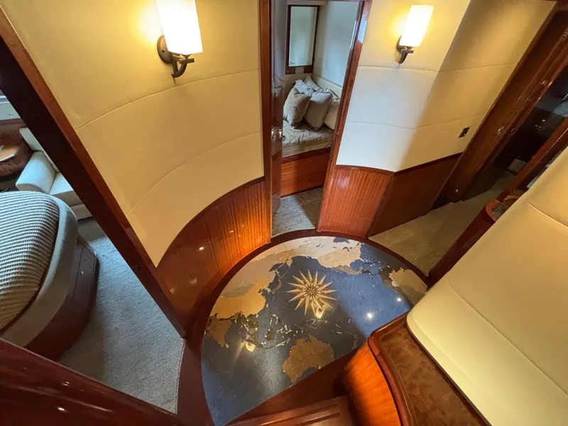 Luxurious interior of 2010 Norseman 80 yacht with elegant wood paneling and plush seating.