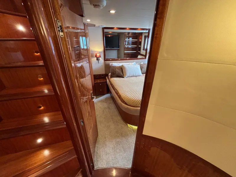 Luxurious Norseman 80 yacht interior with elegant wood finishes, cozy bedroom, and modern amenities.