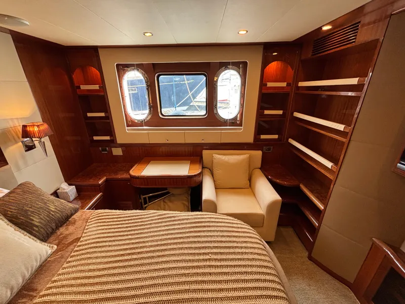 Luxurious Norseman 80 yacht interior with cozy seating, elegant wood finishes, and ample shelving.