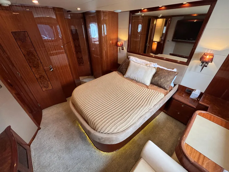 Luxurious bedroom interior of 2010 Norseman 80 yacht with elegant wood finishes.