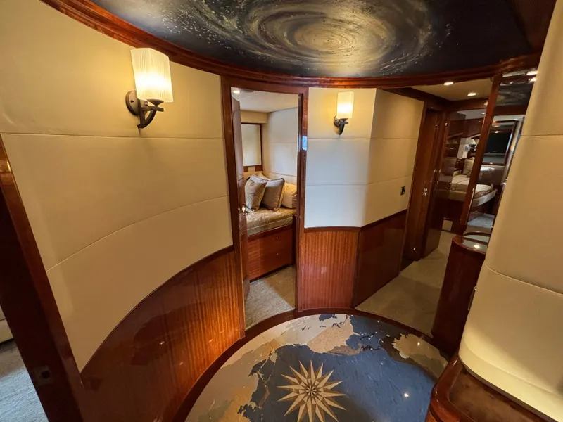 Luxurious interior of 2010 Norseman 80 yacht with elegant wood and nautical decor.