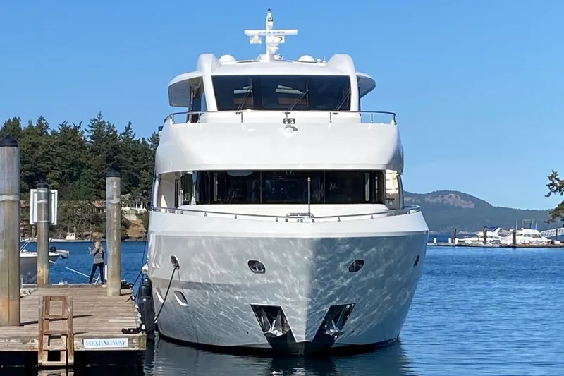Luxury Norseman 80 yacht docked at marina, 2010 model, clear blue sky.