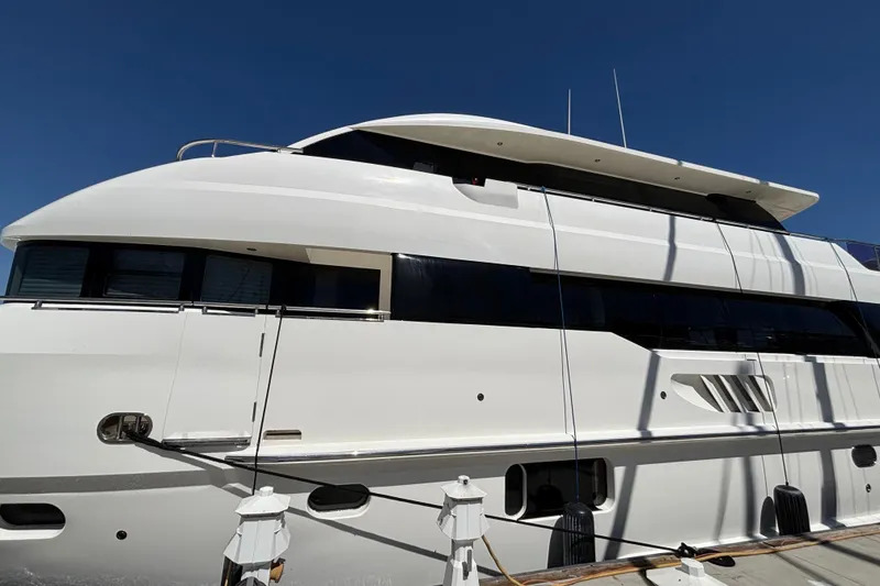 Luxury Norseman 80 yacht docked, 2010 model, sleek white design under clear blue sky.